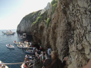 Brightly-painted rowboats line up to take patrons in to the Blue Grotto.